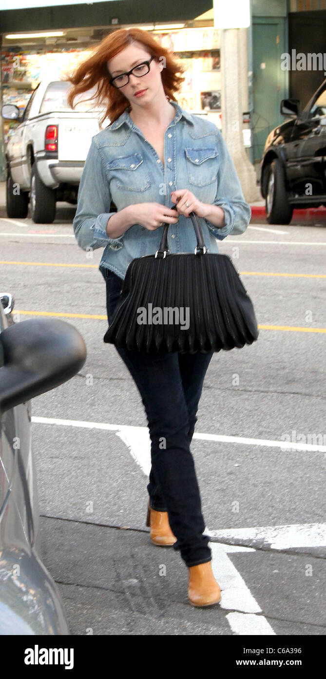 Christina Hendricks out and about with an oversized black handbag and  wearing tight jeans, cowboy boots and a denim shirt Los Stock Photo - Alamy