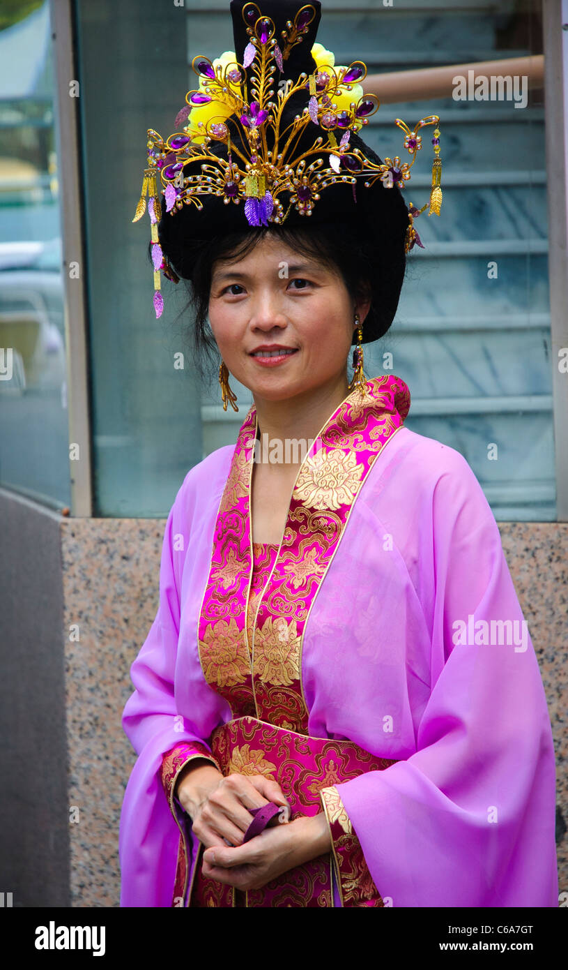 Asian woman wearing traditional costume after Chinese New Year parade. Stock Photo