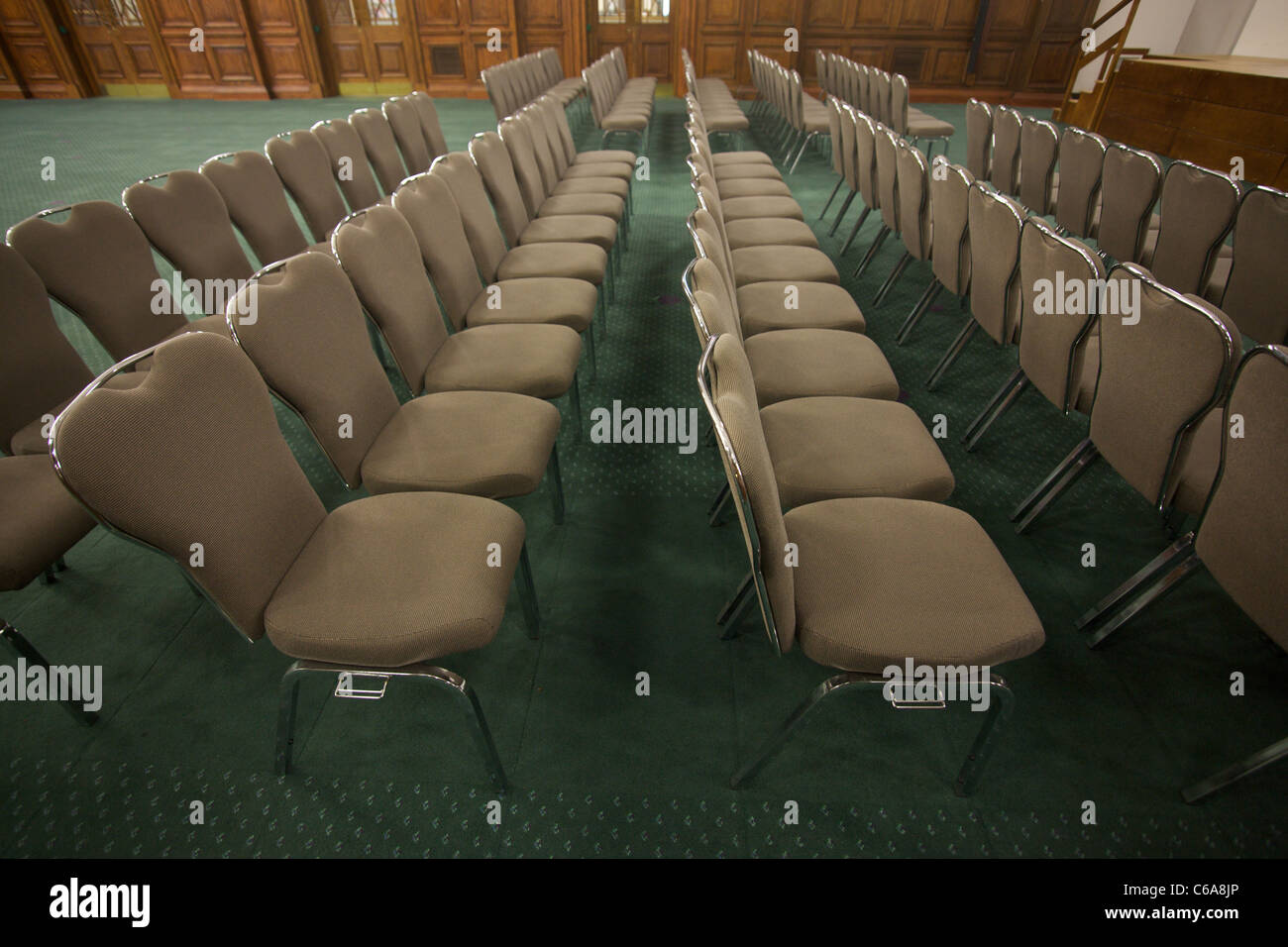 Rows of chairs laid out in meeting room lecture hall hires stock