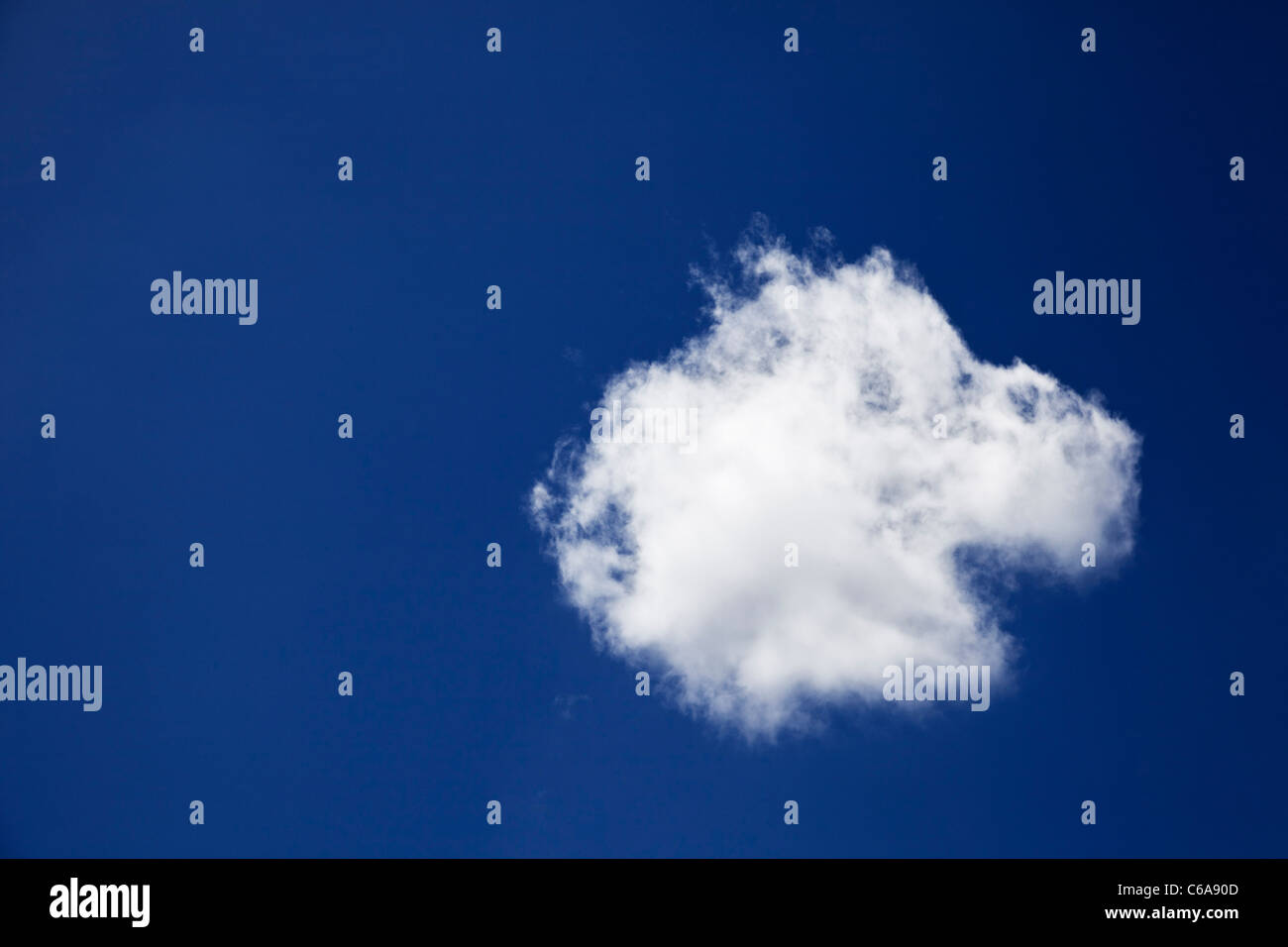 Blue sky and single lone cloud Stock Photo