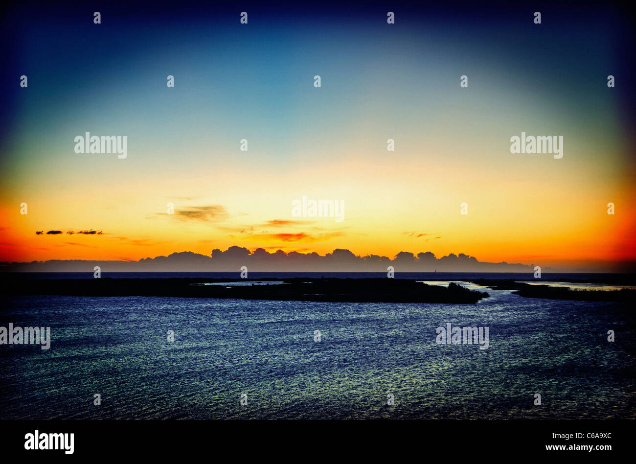 Sunrise. Ebro river at its base level, in front to the sea coast (Tortosa Cape). Ebro Delta