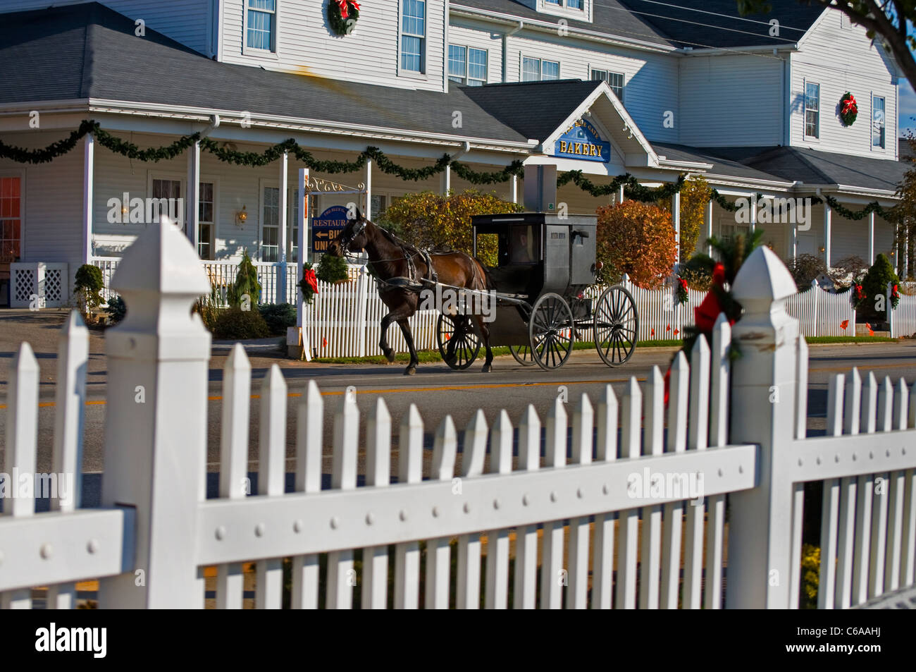 Amish buggy passing by the famous Blue Gate Restaurant and Bakery, popular for its Amish food, in Shipshewana, Indiana. Stock Photo