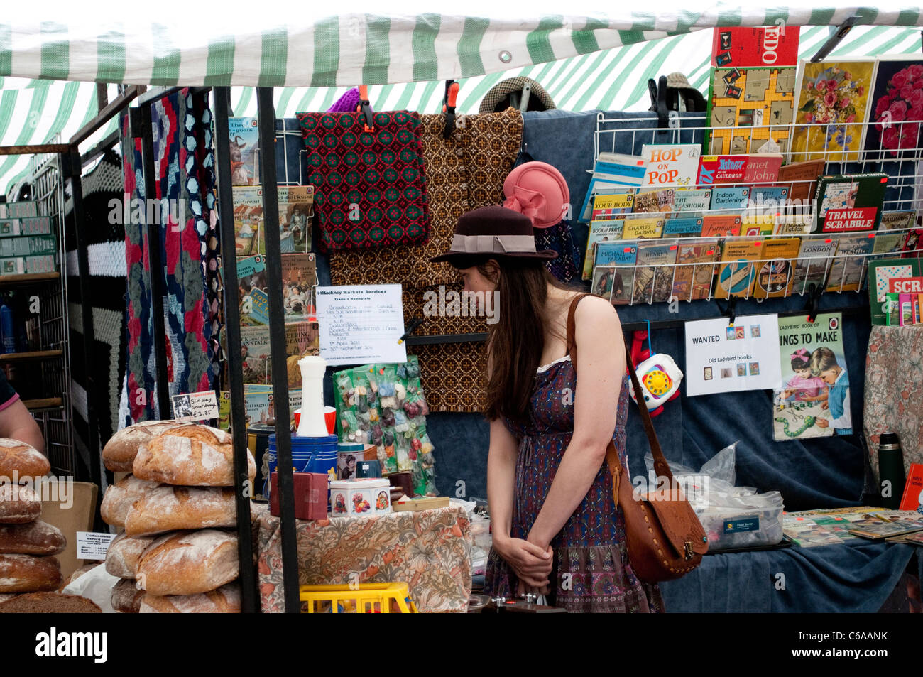 Woman looking at fabrics, Broadway Market, Hackney, London, UK Stock Photo