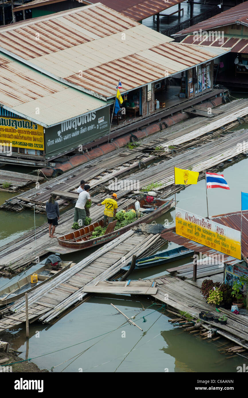 Unloading bananas at a floating village on the river Songaria, in Sangkhlaburi, Kanchanaburi province Thailand Stock Photo