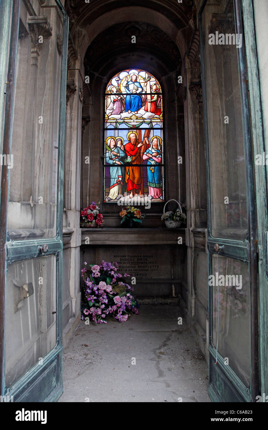 Stained glass window on a grave or mausoleum in the graveyard at the