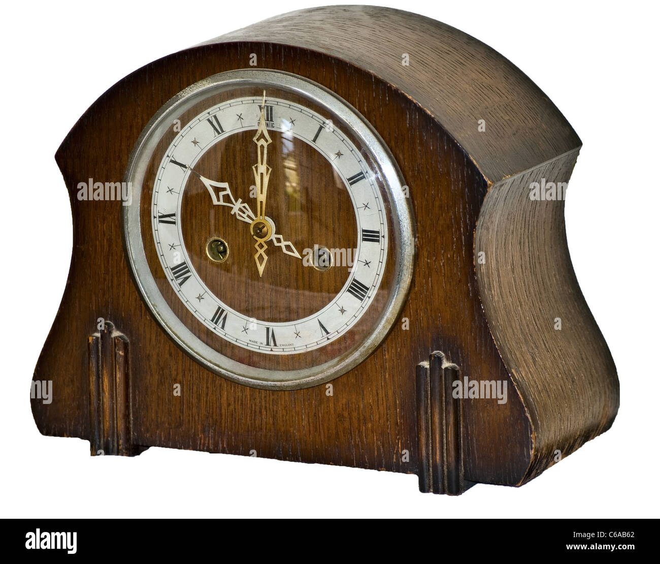 An early wooden mantelpiece clock (timepiece) cut out. Stock Photo
