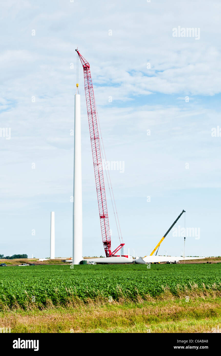 Components for a horizontalaxis wind turbine are being assembled on a