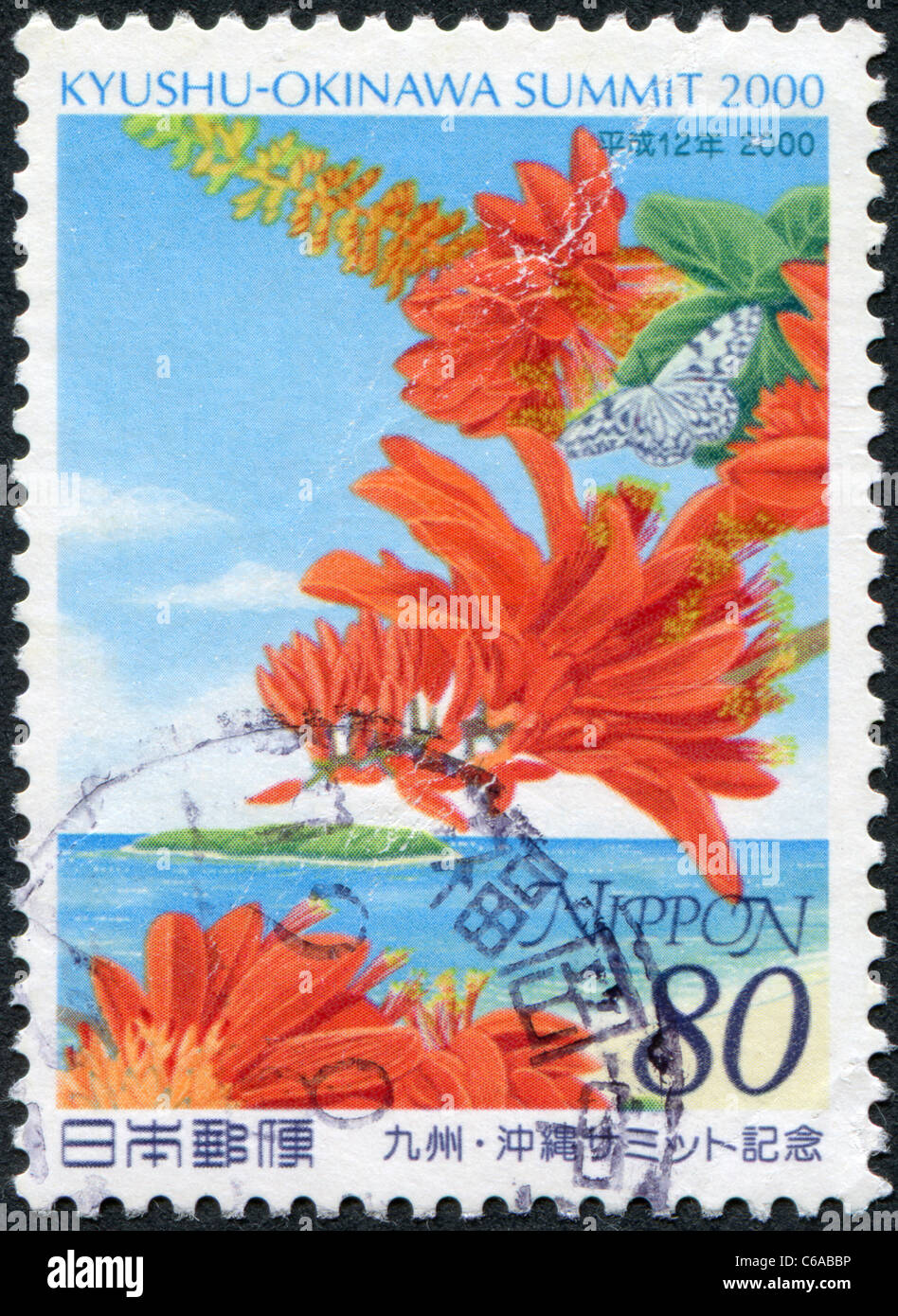 JAPAN-2000: A stamp printed in Japan, dedicated to the Kyushu-Okinawa Summit, shows Ogomadara Butterfly and Erythrina variegata Stock Photo