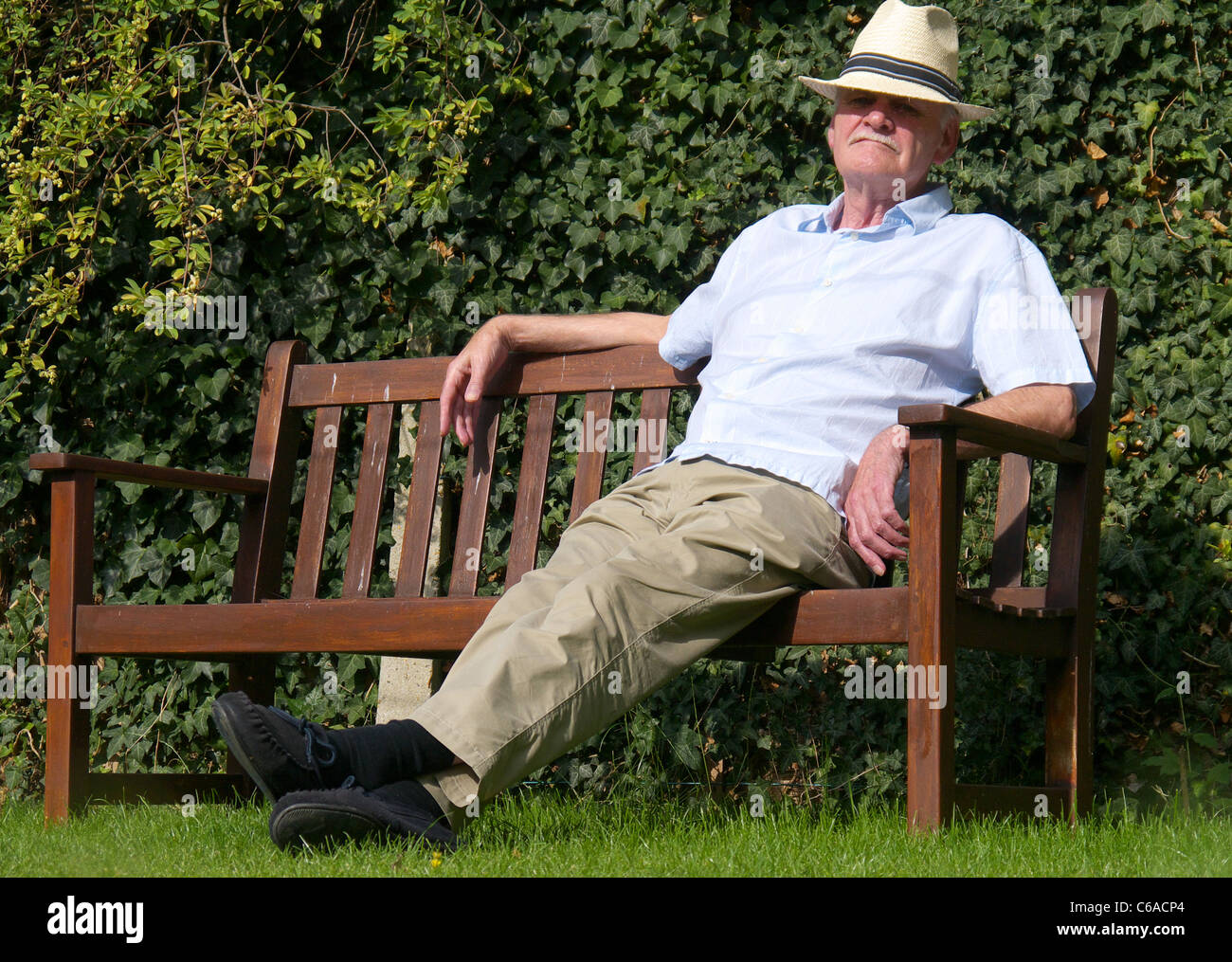Elderly Man Sleeps on his Garden bench Stock Photo Alamy