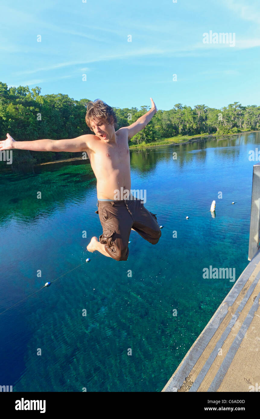 Young man jumps into Wakulla Spring from high platform Stock Photo