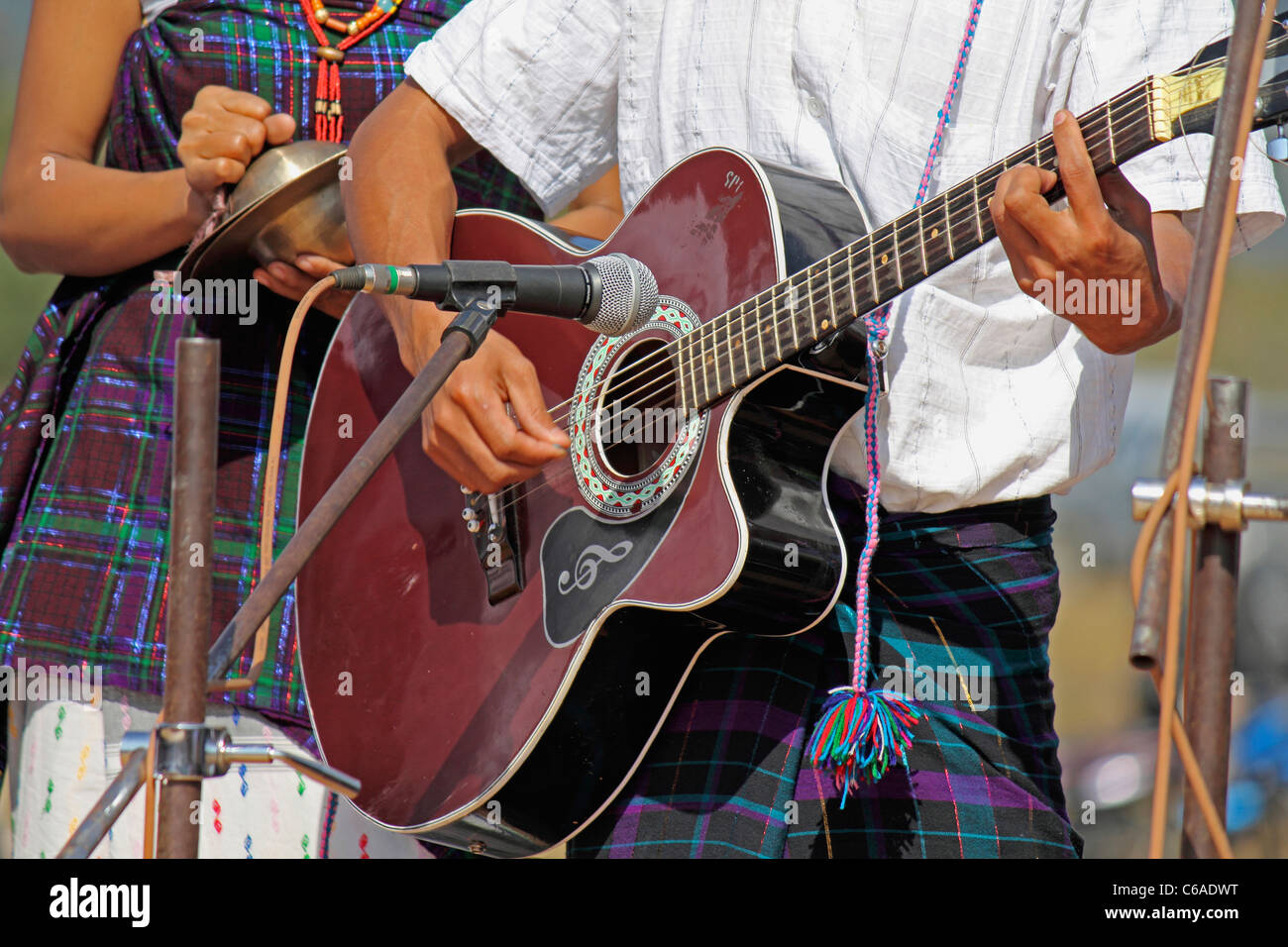 Singpho Man playing guitar at Namdapha Eco Cultural Festival, Miao, Arunachal Pradesh, India Stock Photo