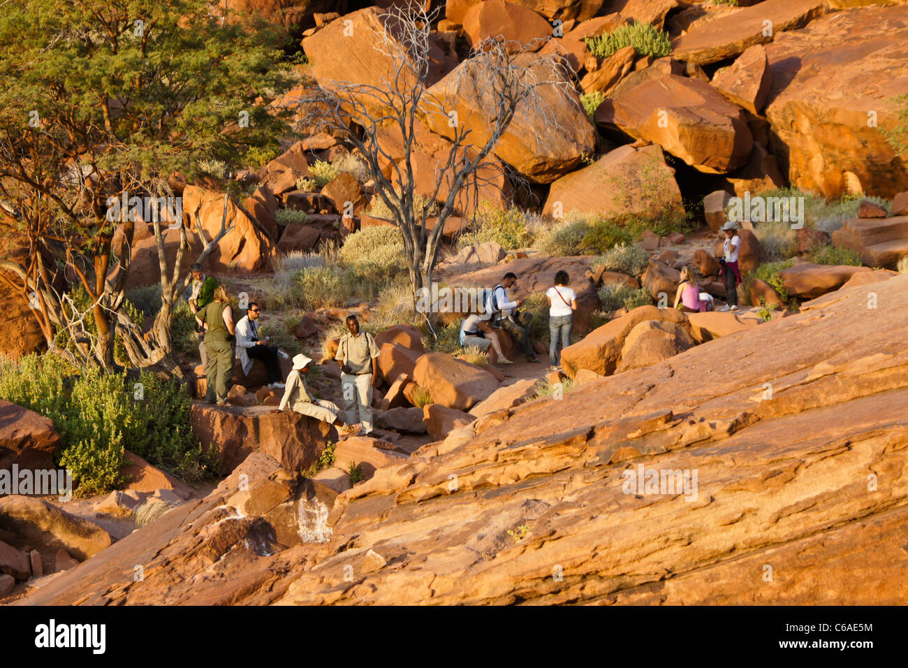 Tourists visiting San rock art site, Twyfelfontein, Namibia Stock Photo