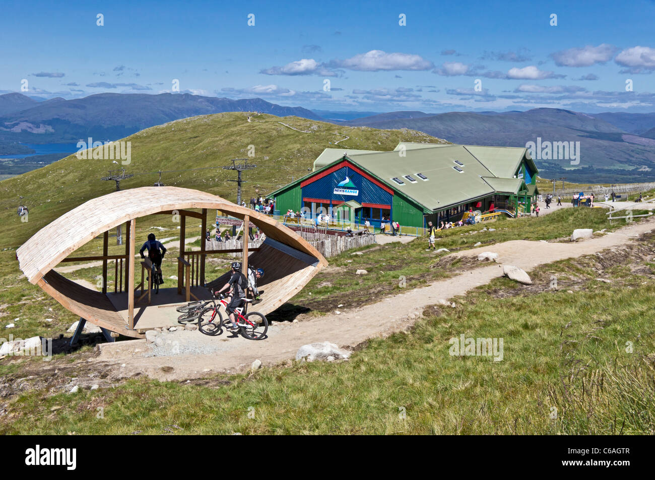 Bikers preparing to descend Off Beat Downhill track at Nevis Range top station on Aonach Mor