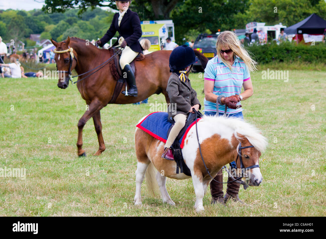 A very young rider at the Denmead Horse Show, sits on her small pony