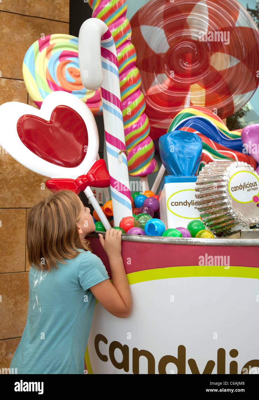 A young girl looking at sweets; the Candylicious store, Sentosa Island Singapore Stock Photo