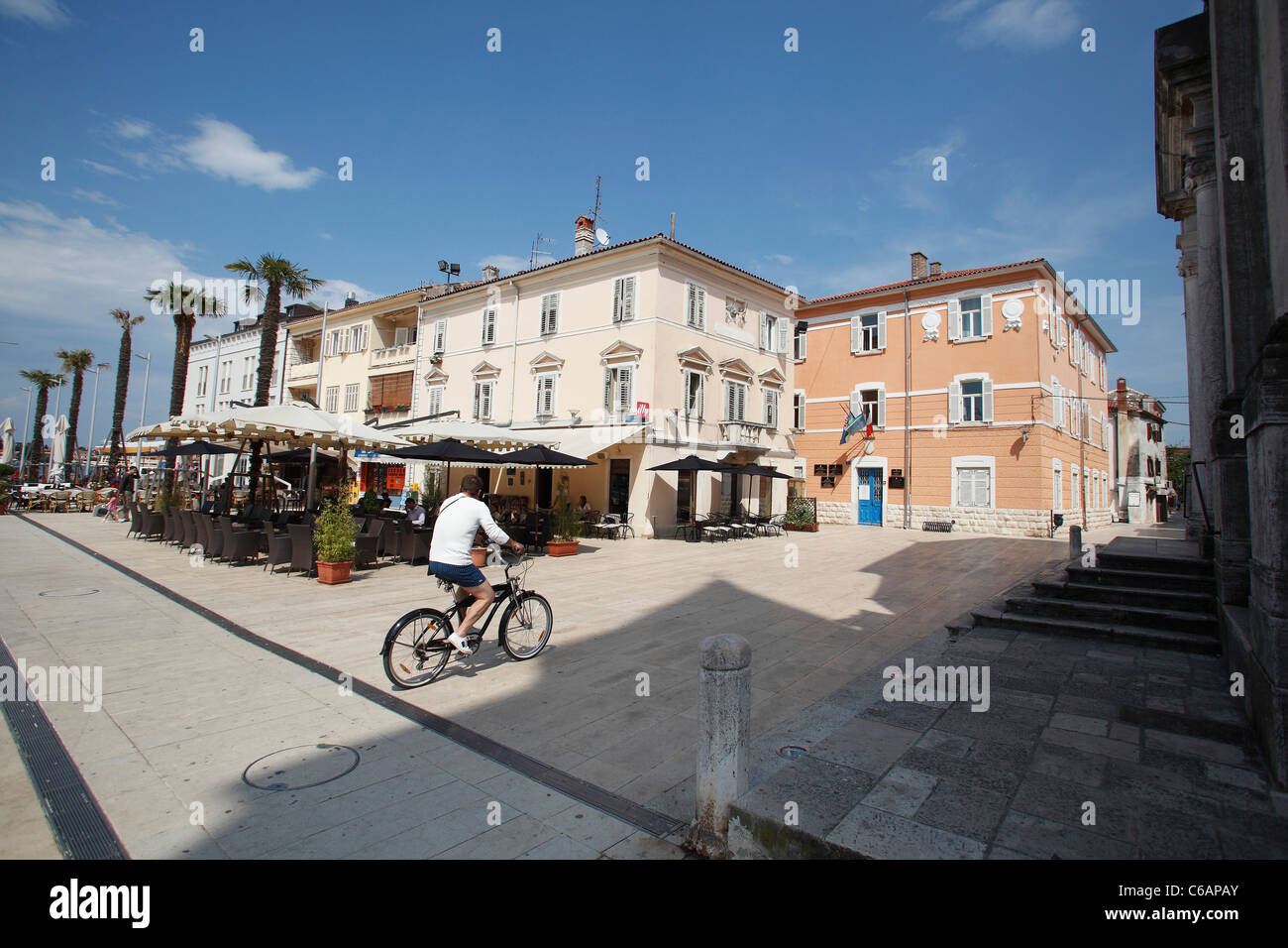 Cyclist in the Piazza Slobode Liberta in Umag,Croatia. Stock Photo