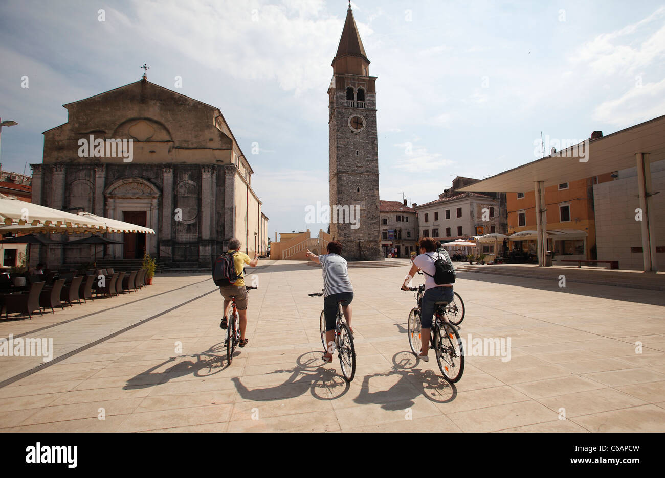 Tourists on bicycles in the Piazza Slobode Liberta, Umag,Croatia. Stock Photo