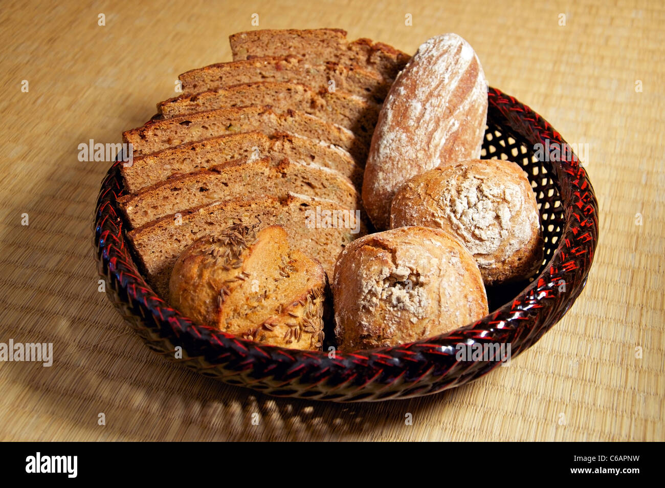 Wholegrain Bread and Buns in a basket Stock Photo