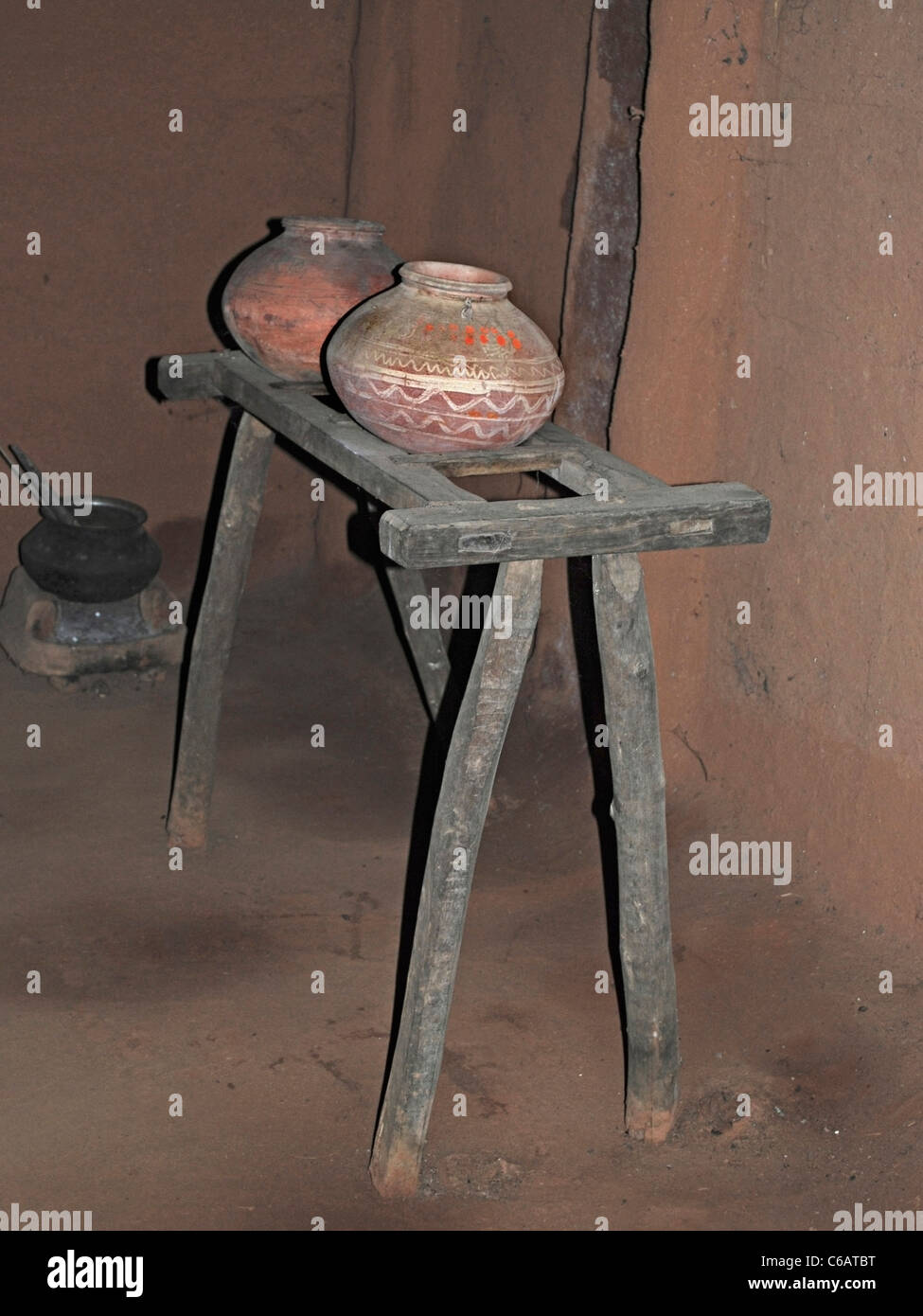 Mud pots for filling water on wooden rack in a museum, Madhya pradesh ...