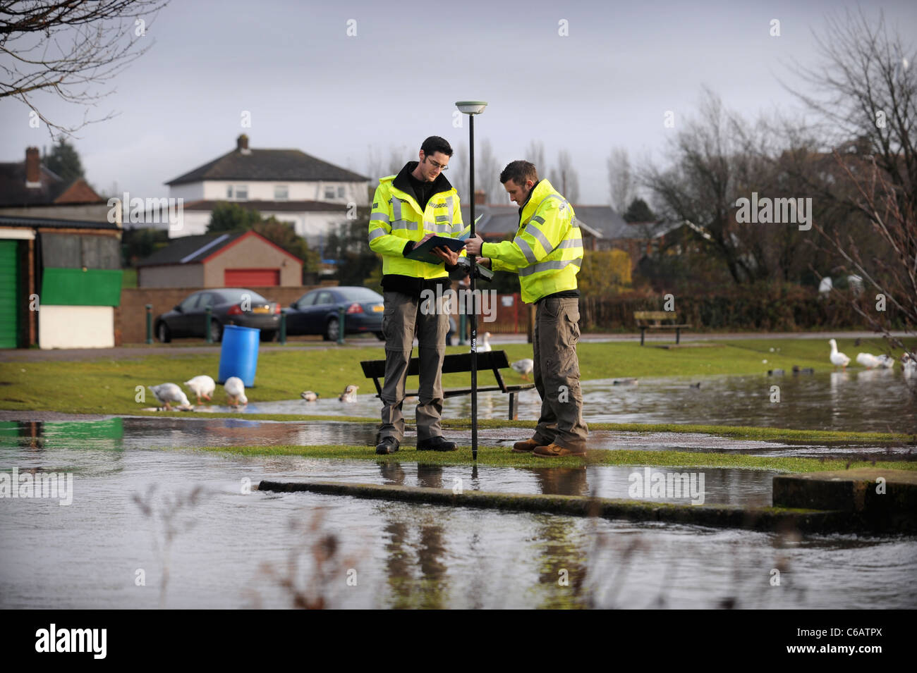 Officers from the Environment Agency using GPS equipment to monitor flood levels near Lydney, Gloucestershire UK Stock Photo