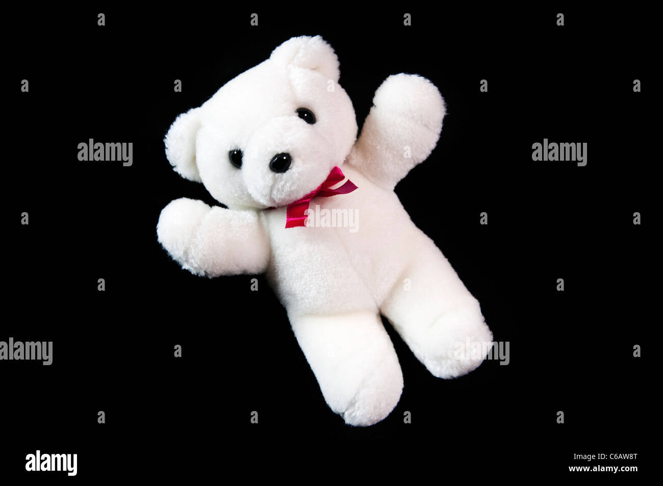 White teddy bear on black background Stock Photo