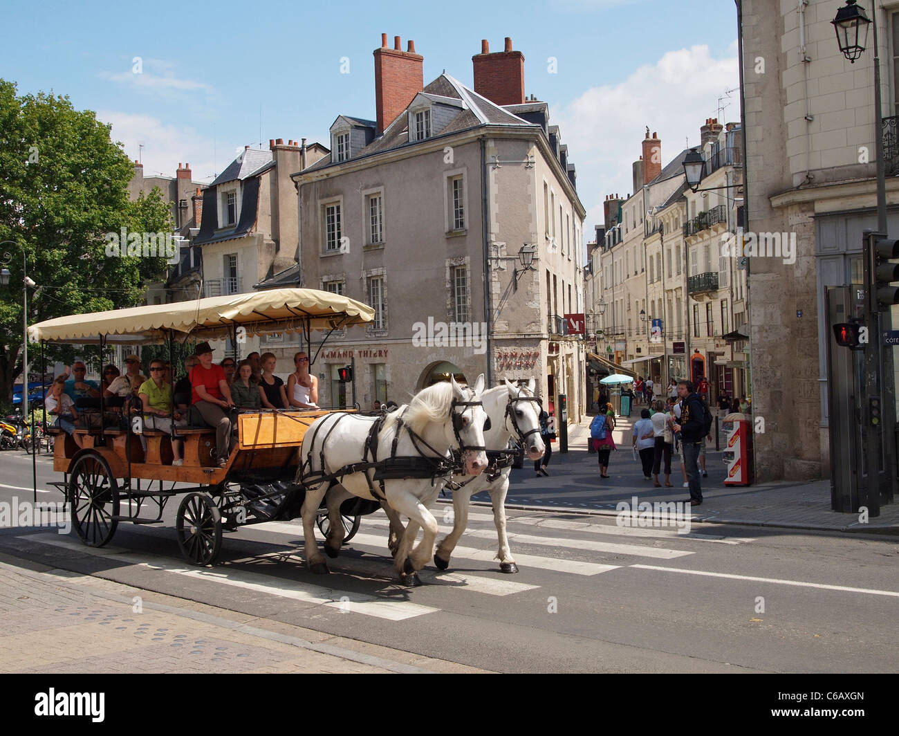 Horse and carriage with sightseeing tourists in the city center of Blois, Loire valley, France Stock Photo