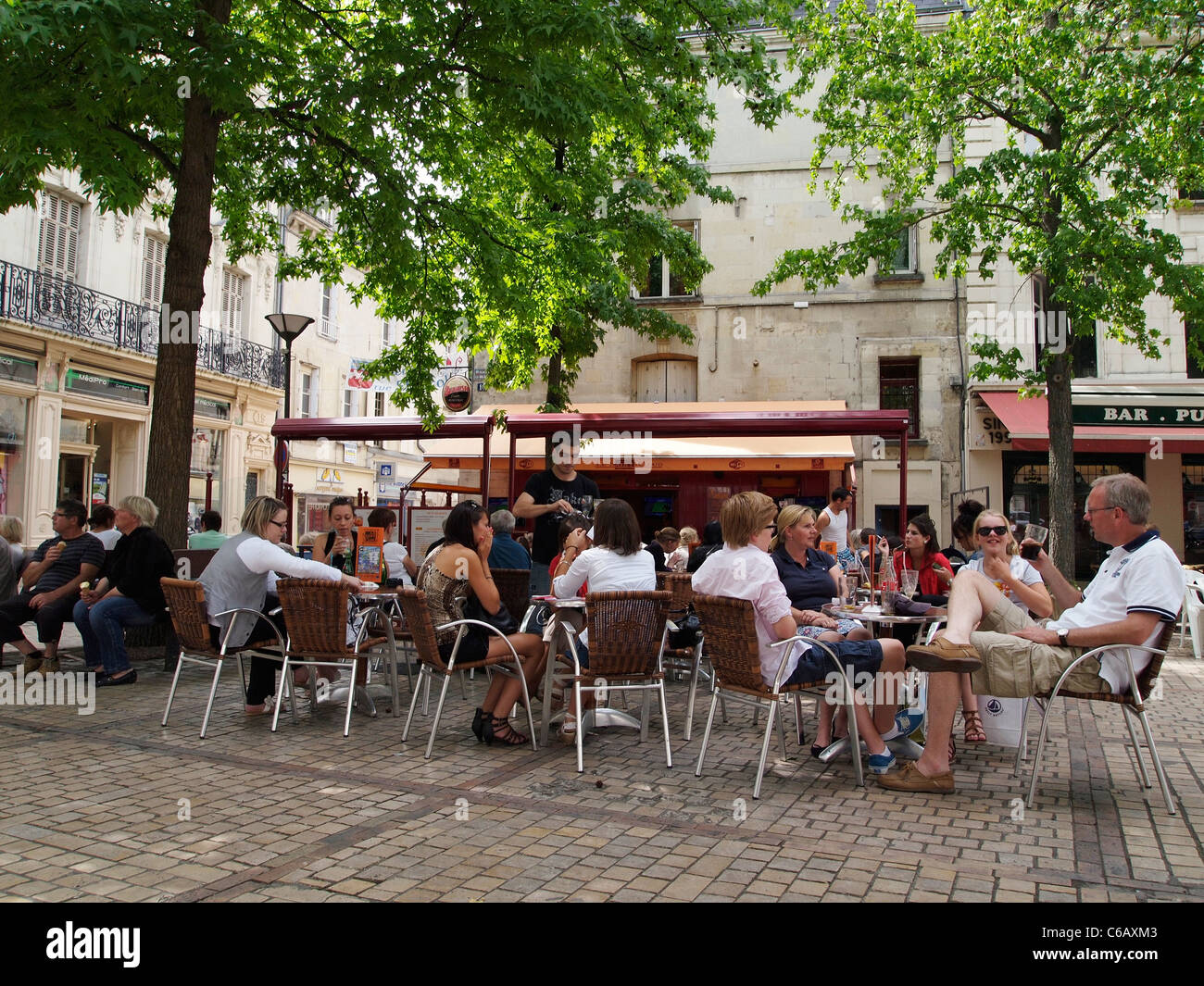 Tourists sitting on a shady square in Saumur, Loire valley, France