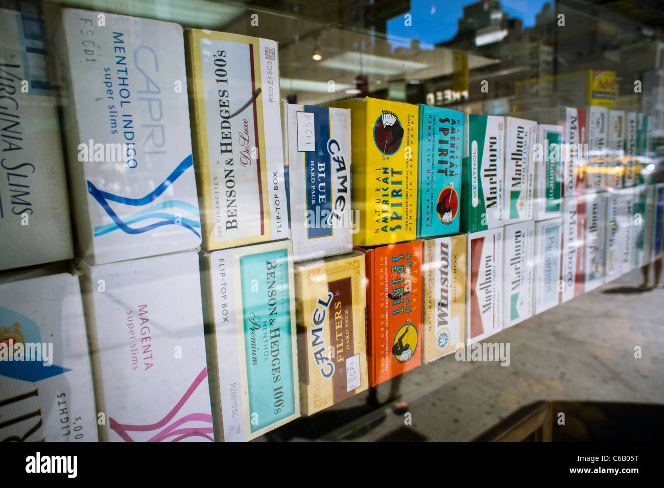 Cartons of cigarettes in the window of a grocery store in New York on Monday, August 22, 2011. (© Richard B. Levine) Stock Photo