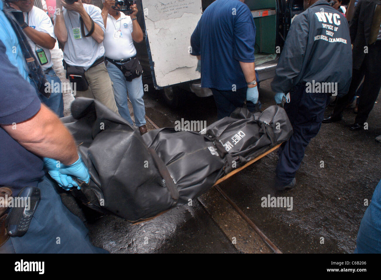 Workers from the NYC Office of the Chief Medical Examiner remove three bodies after a murder-suicide Stock Photo