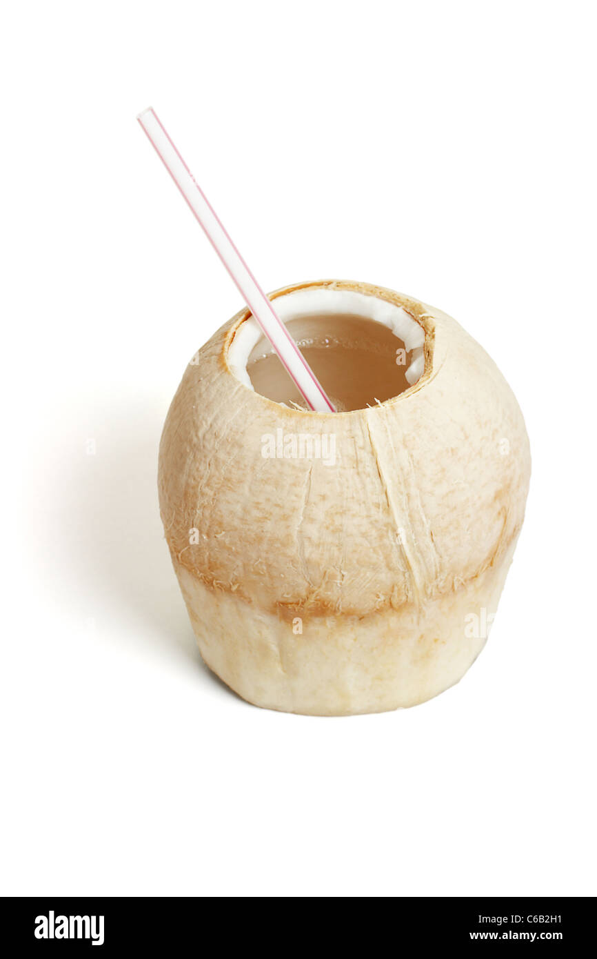Fresh cool drink in shaved coconut shell on white background Stock Photo