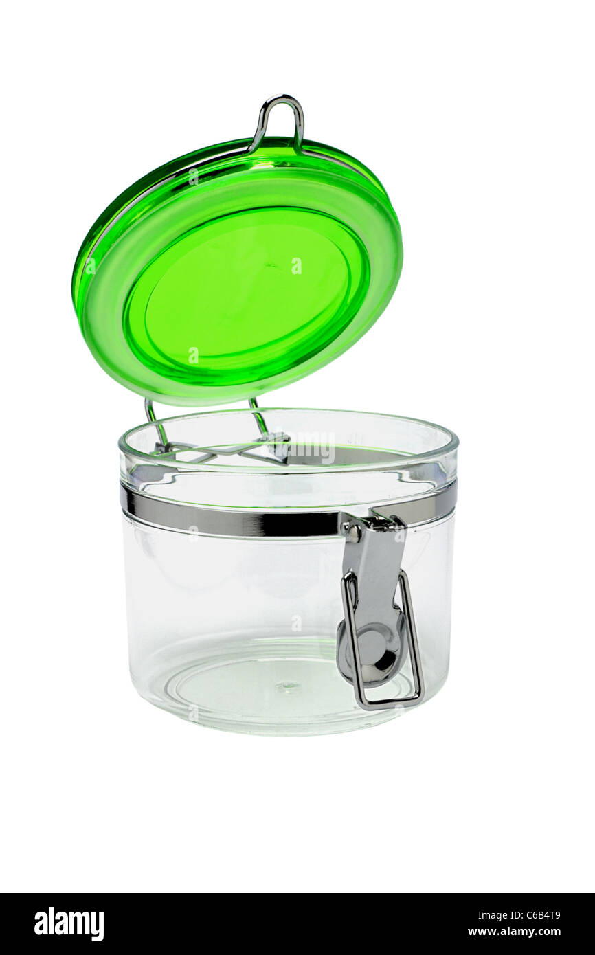 Open glass container with green plastic lid on white background Stock Photo