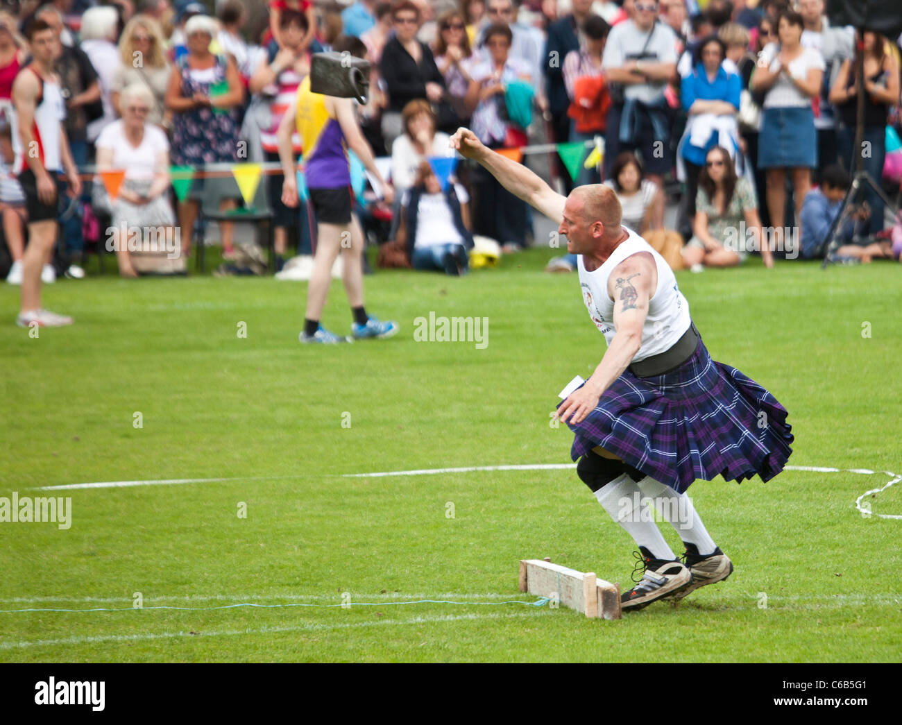 Kilted athlete throwing a 56lb weight during one of the 'heavy events