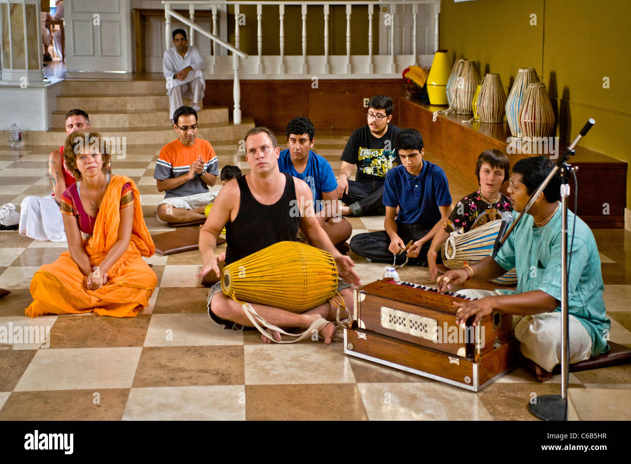Worshipers chant while playing on a harmonium and a 'Mirdanga' drum during services at a Hindu temple in Laguna Beach, CA. Stock Photo