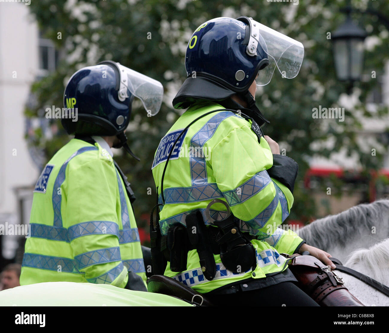 Two mounted Metropolitan police officers in full riot gear, outside Chelsea Football club, London. Stock Photo