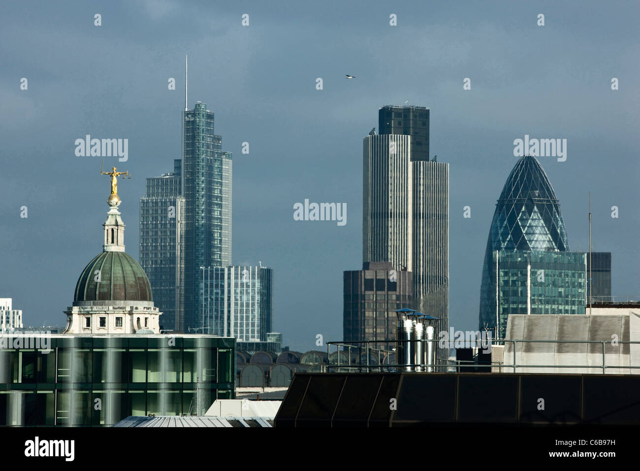 Lady Justice stands high on top of the Old Bailey Law courts with the city of London in the