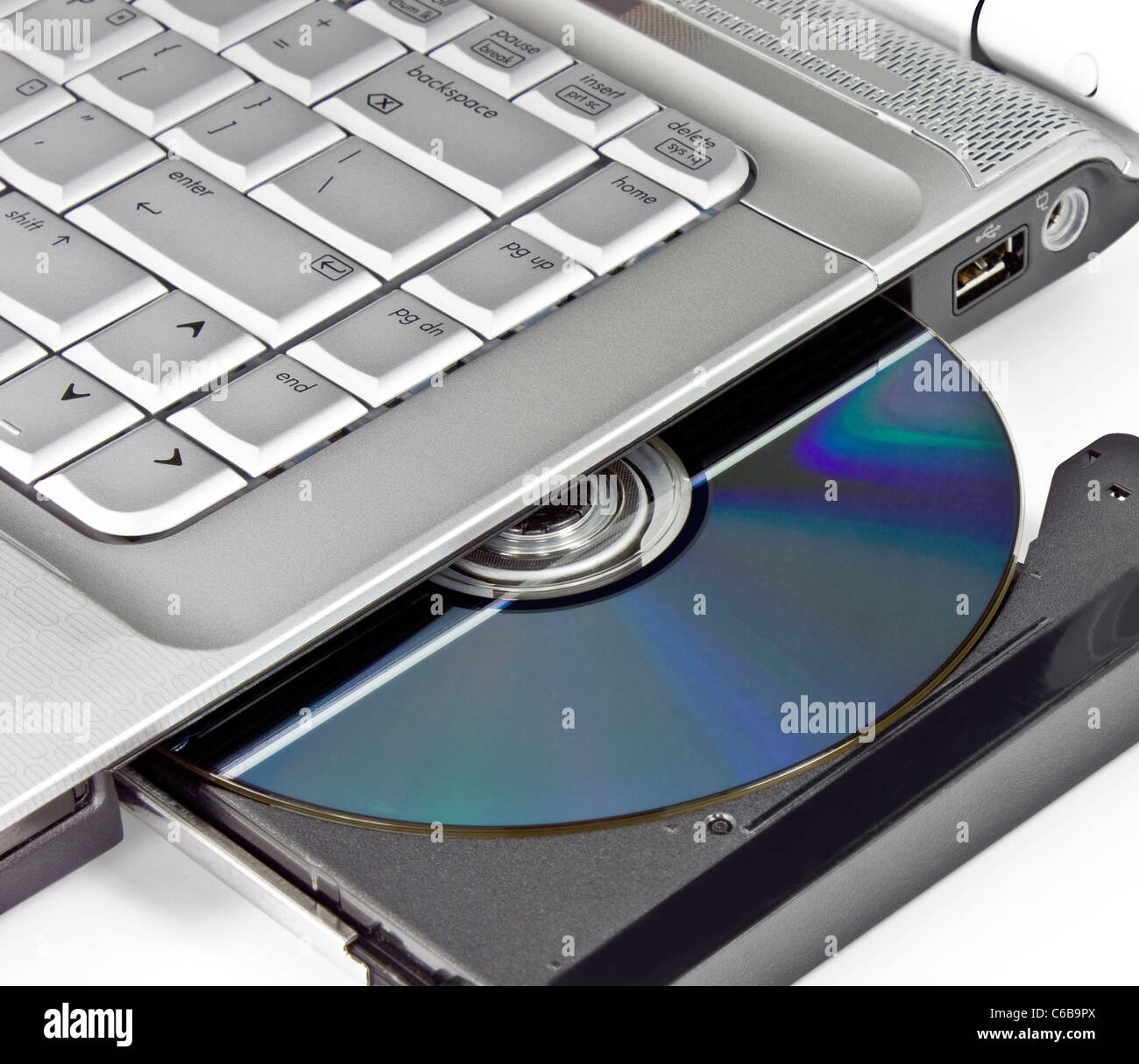 Optical disc placed in a laptop drive Stock Photo