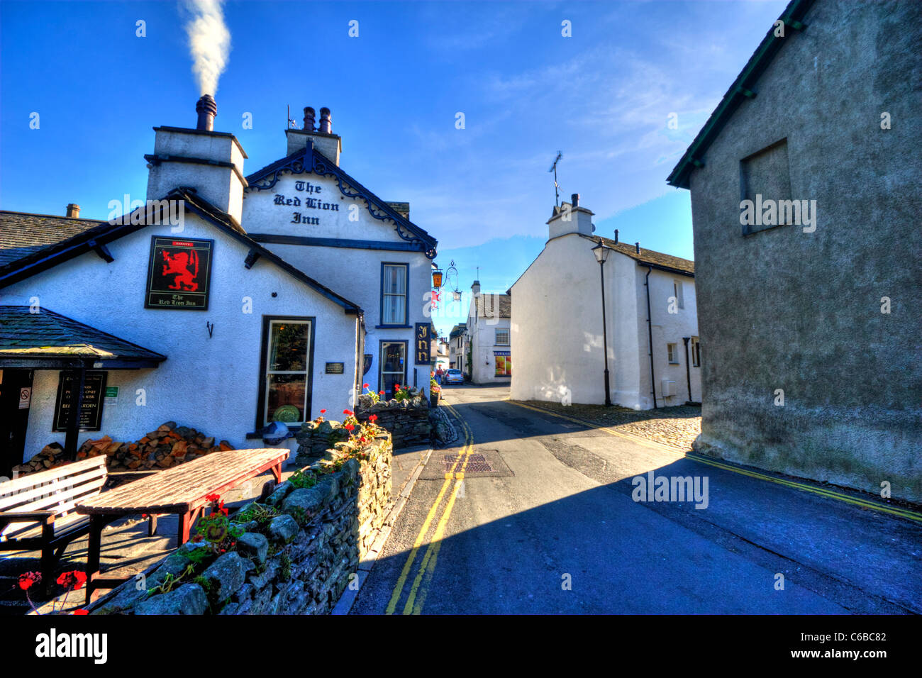 Hawkshead village in Cumbria, picturesque white washed homes HDR tonemapped to add drama, dramatic effect Stock Photo