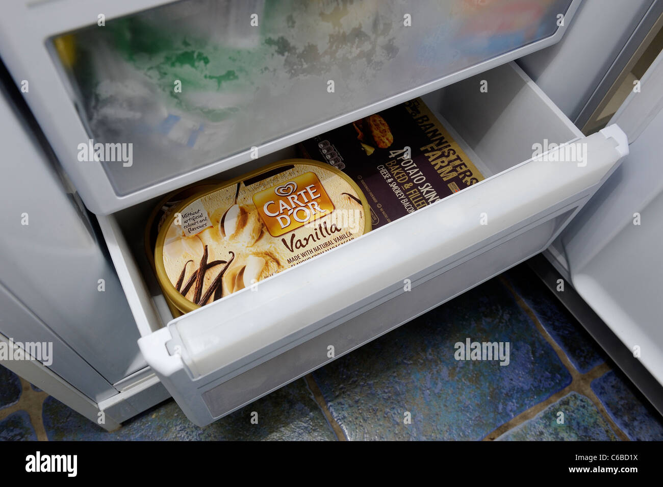 drawer of a domestic freezer with ice cream inside england uk Stock Photo