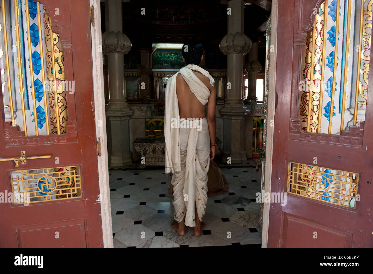 Man Praying in Babu Amichand Panalal Adishwarji Jain Temple in Malabar Hill Mumbai, India Stock Photo