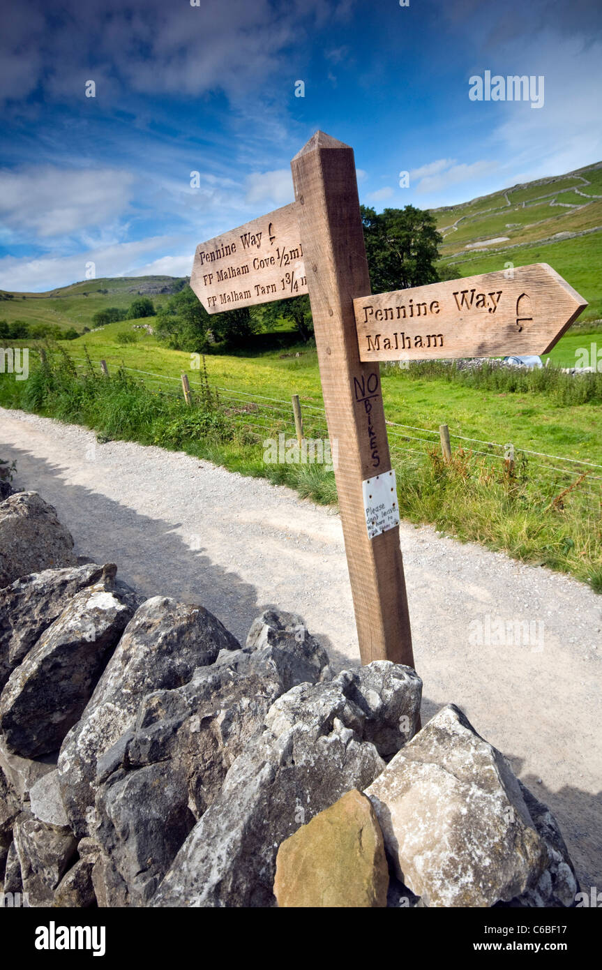 A signpost pointing to Malham Cove and the Pennine Way in the Yorkshire Dales National Park, England Stock Photo