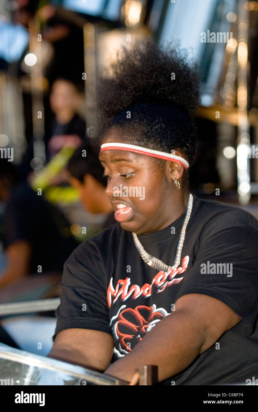 Band member from Metronomes Steel Orchestra playing steel drum at the Notting Hill Panorama
