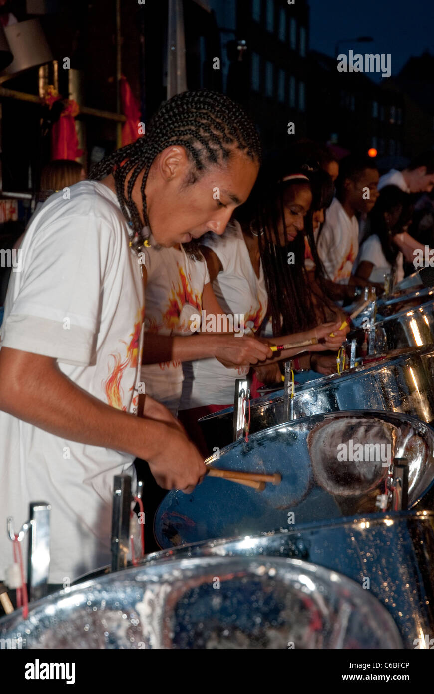 Band member from Rapso Steel Orchestra, Pan on Fire, playing steel drum