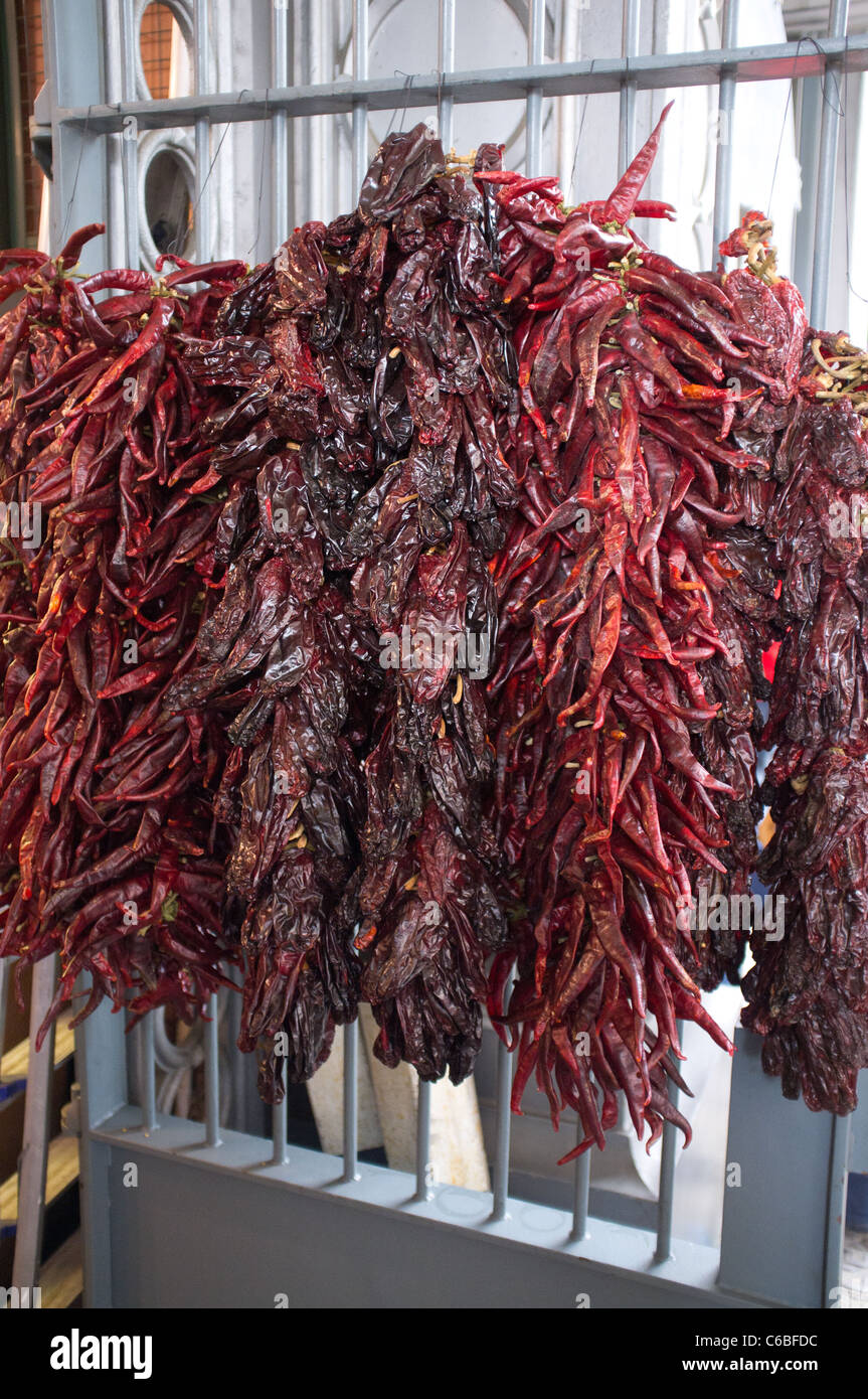 Bunches of dried chillies hanging on a door at Borough Market, Southwark, London Stock Photo
