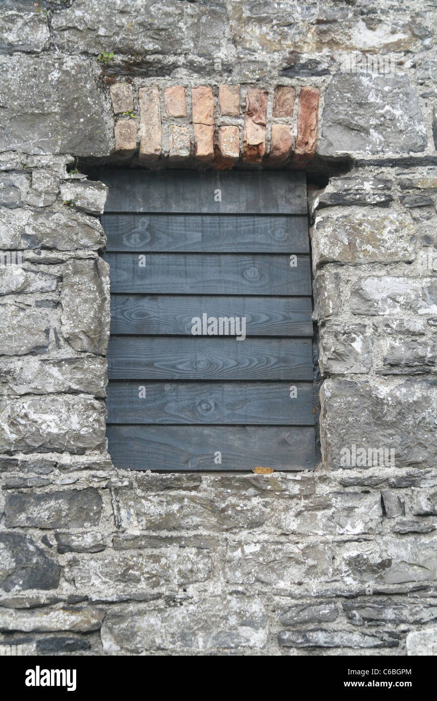 Shuttered Window in Stone Wall Stock Photo - Alamy