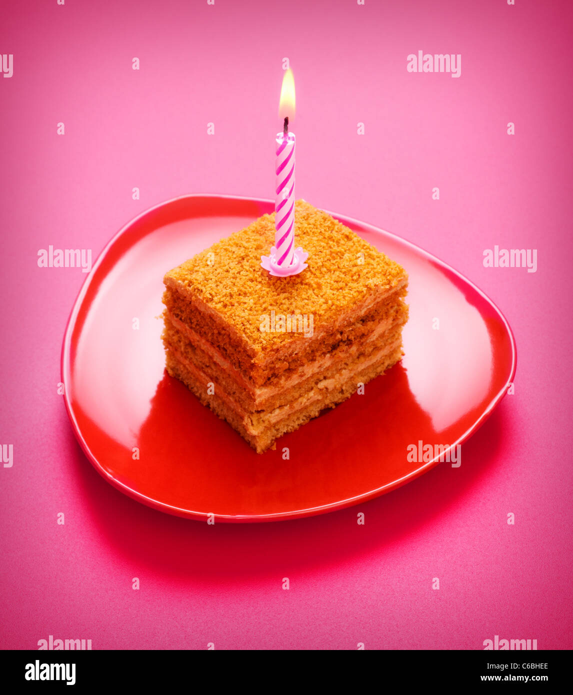 birthday cake with candle on pink background Stock Photo - Alamy