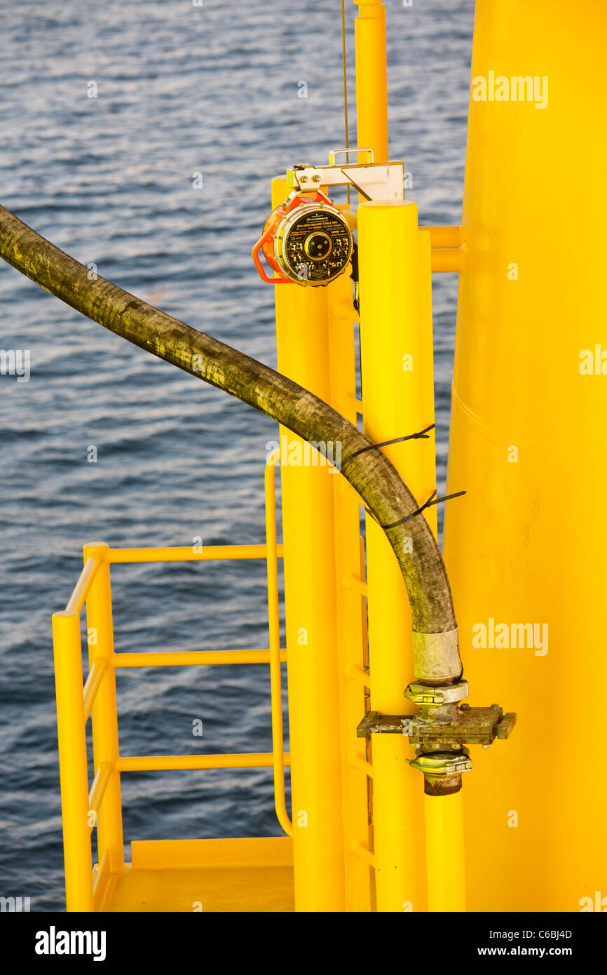 A pipe carries specialist grout to cement a transition piece to a monopile, on the Walney offshore windfarm. Stock Photo