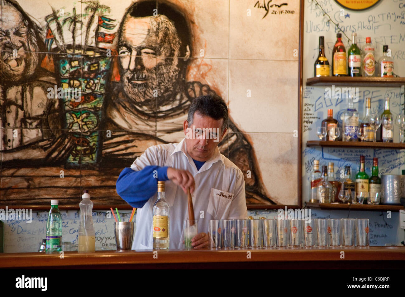 Cuba, Havana. La Bodeguita del Medio. Bartender at Work. Stock Photo