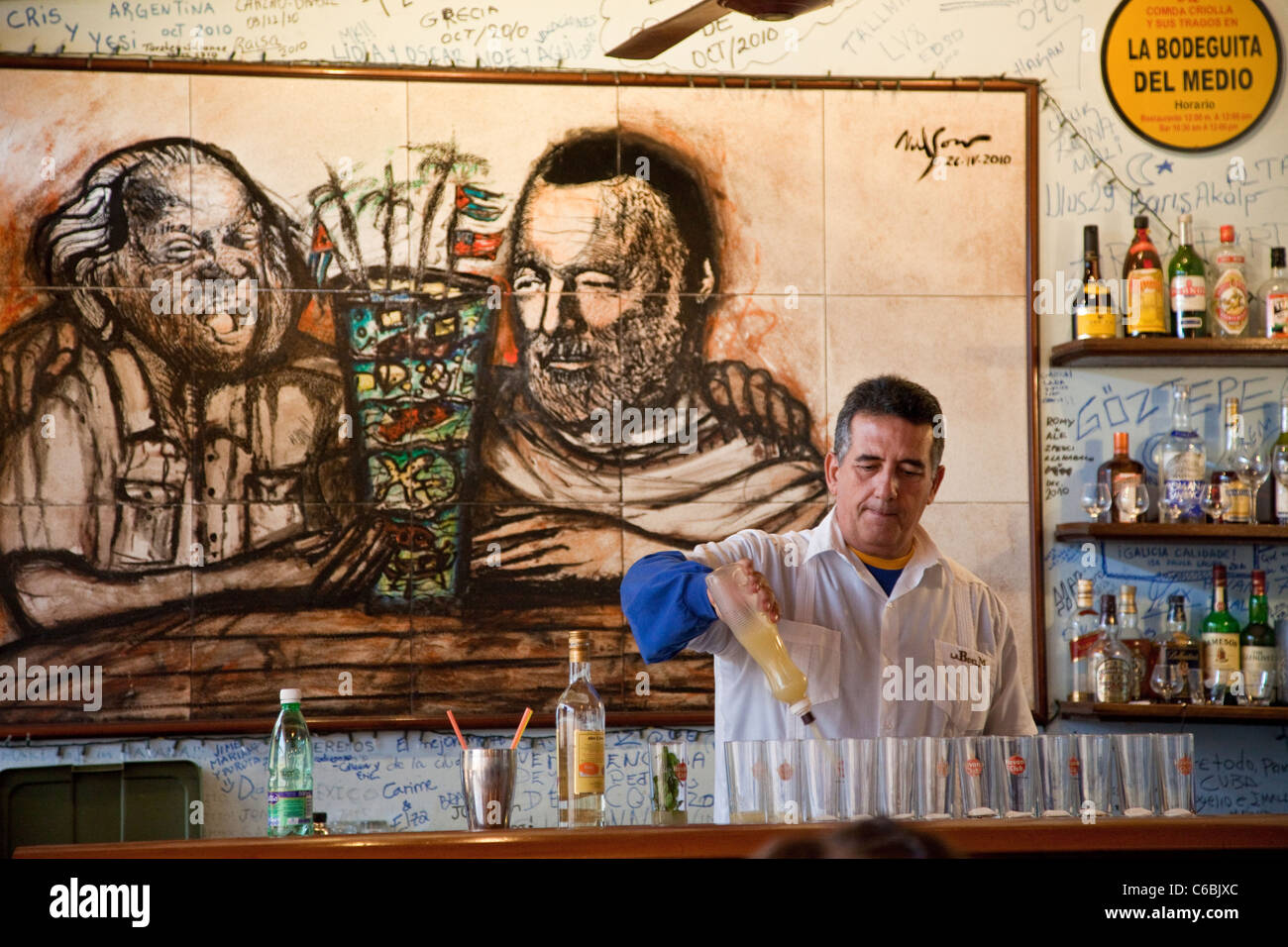 Cuba, Havana. La Bodeguita del Medio. Bartender at Work, Mixing Mojitos. Stock Photo