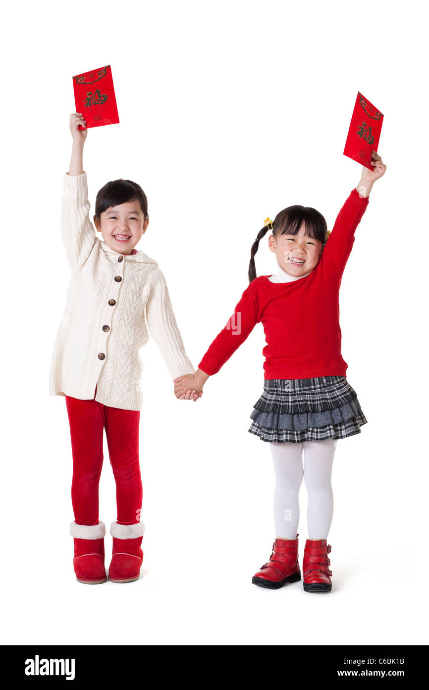 Two Chinese girls holding red envelopes Stock Photo