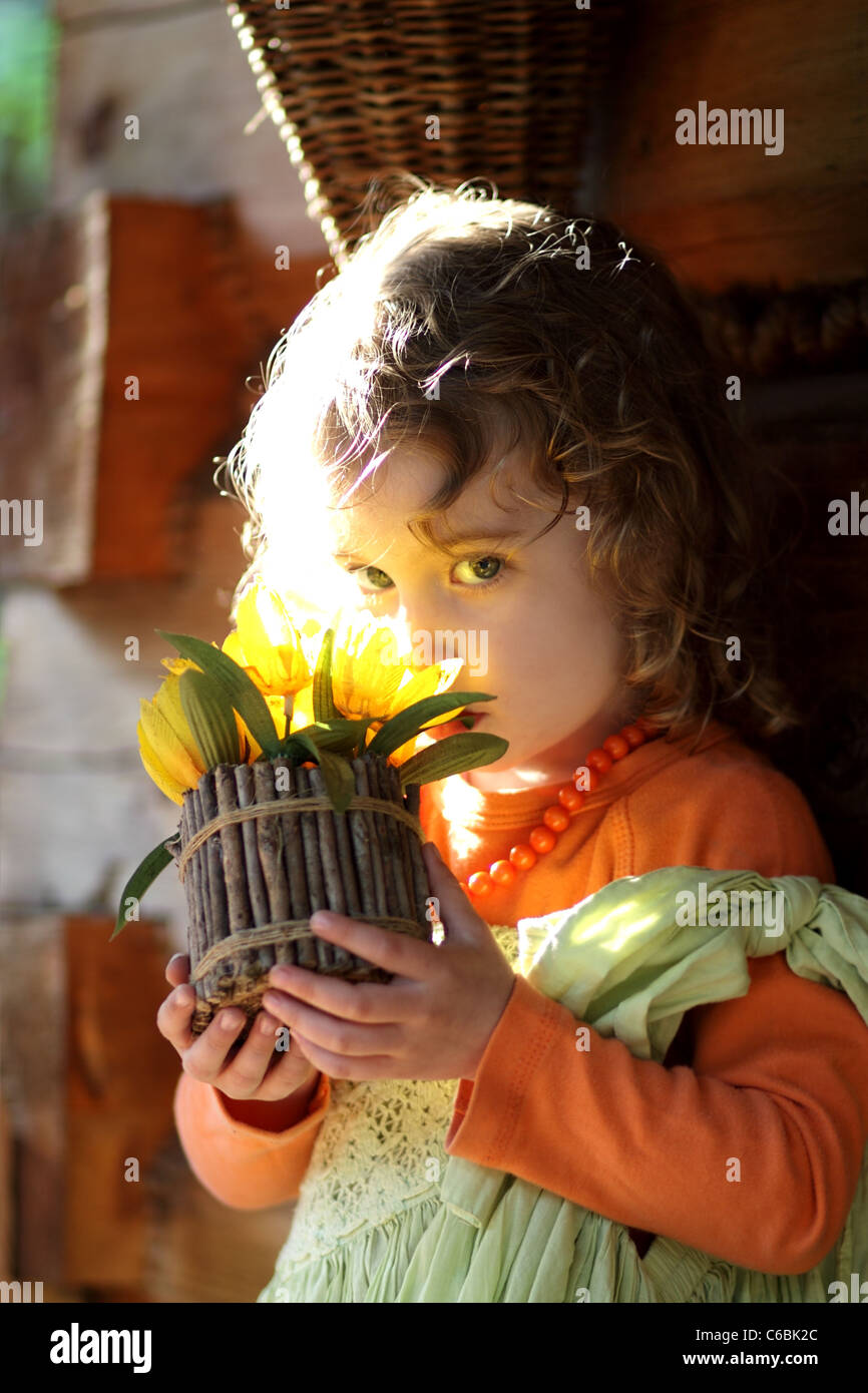 beautiful girl smelling flowers Stock Photo